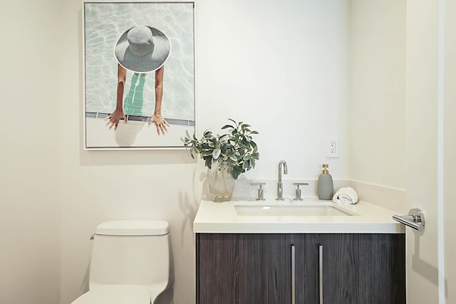 bathroom featuring toilet and vanity