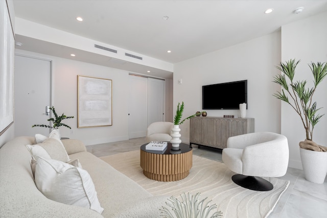 living room featuring recessed lighting and visible vents