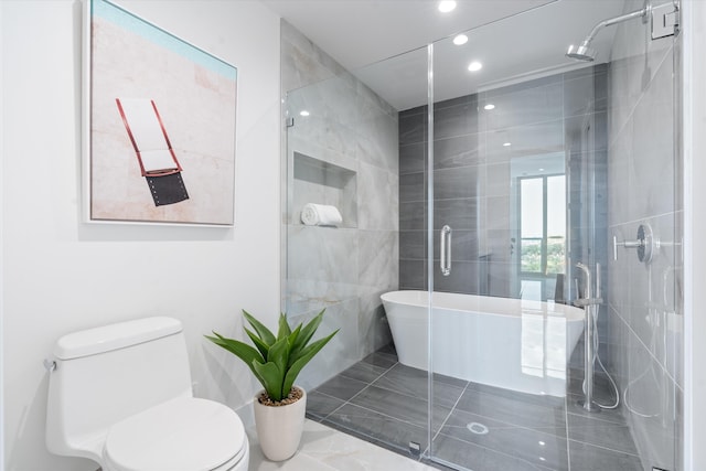 full bath with toilet, recessed lighting, a stall shower, tile patterned floors, and tile walls