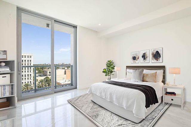 bedroom featuring recessed lighting, expansive windows, a city view, and access to outside