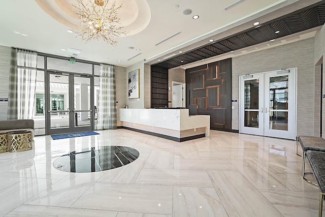 welcome area featuring a chandelier and french doors