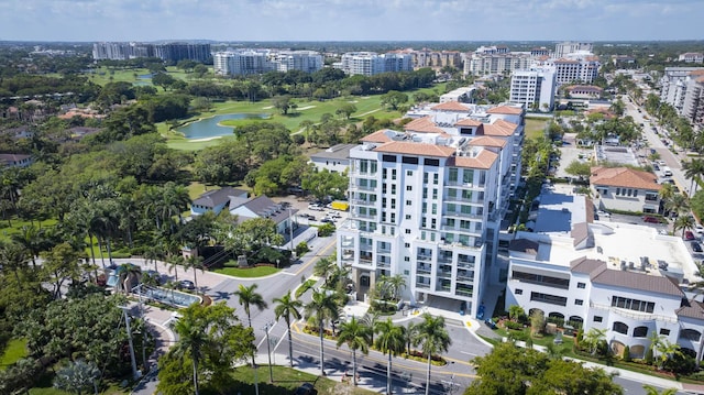 drone / aerial view with a water view, a city view, and golf course view