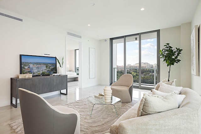 living area featuring visible vents, recessed lighting, and expansive windows