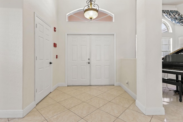 entrance foyer featuring baseboards and tile patterned floors