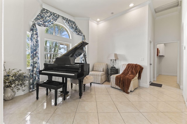 sitting room with tile patterned flooring, a high ceiling, and ornamental molding