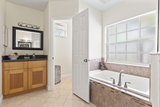 full bathroom featuring tile patterned flooring, vanity, and a bath