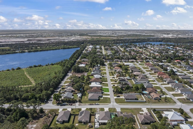 drone / aerial view featuring a residential view and a water view