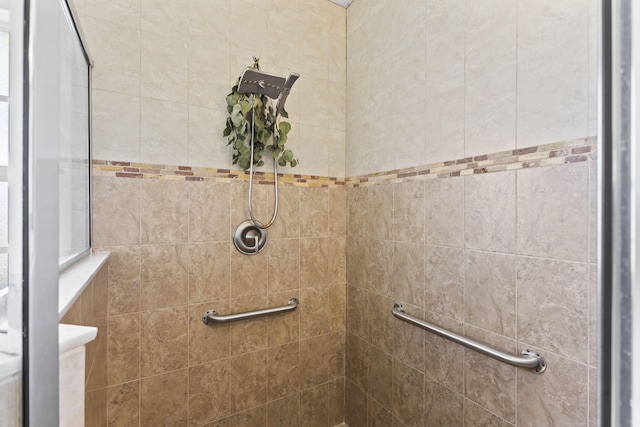 bathroom with a tile shower