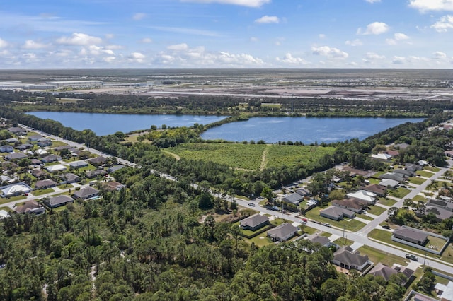 birds eye view of property with a water view and a residential view