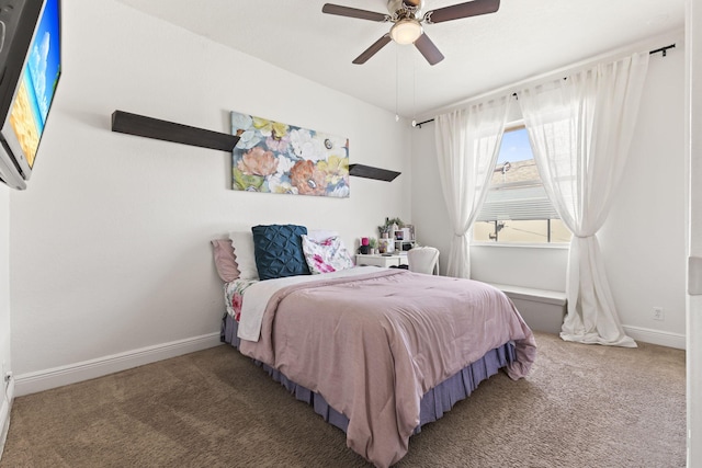 bedroom with a ceiling fan, baseboards, and carpet flooring