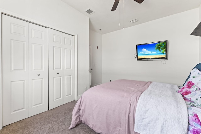 bedroom with a closet, carpet flooring, visible vents, and a ceiling fan