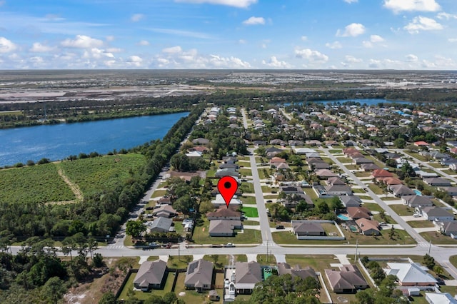 bird's eye view featuring a water view and a residential view