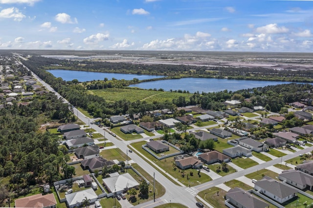 birds eye view of property with a water view and a residential view