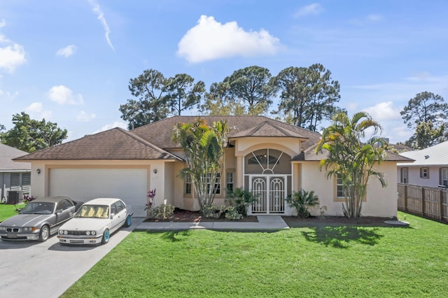 ranch-style house with an attached garage, driveway, a front lawn, and stucco siding