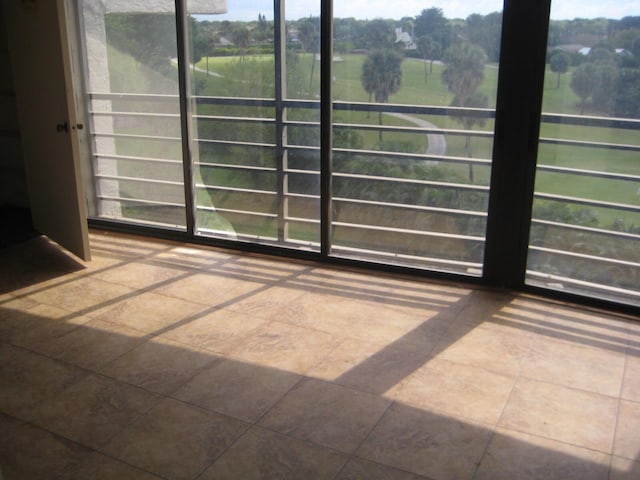 unfurnished sunroom featuring a rural view