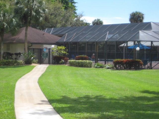 view of home's community featuring a gate, a lawn, and fence