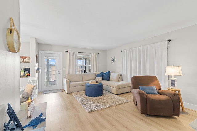 living room featuring baseboards and light wood finished floors