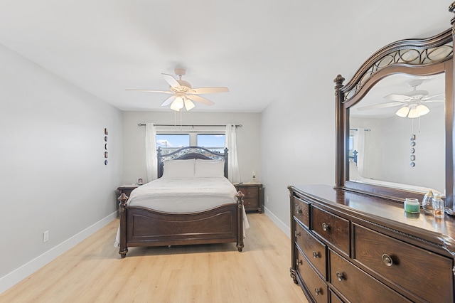 bedroom featuring light wood-type flooring, ceiling fan, and baseboards