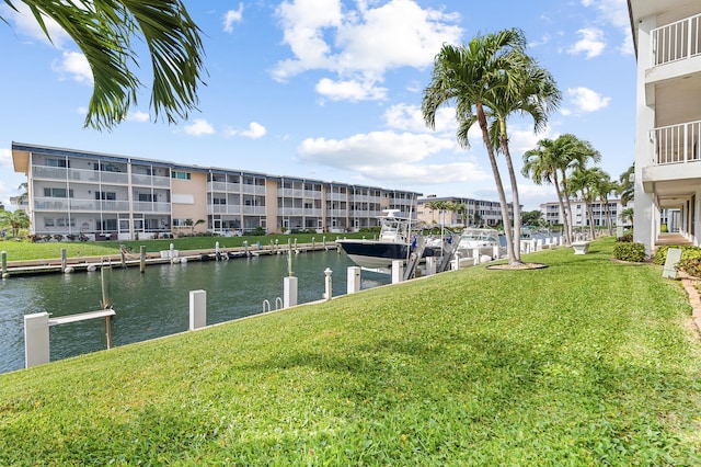 dock area featuring a water view and a lawn