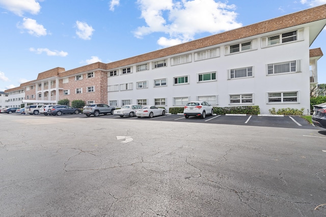 view of building exterior with uncovered parking