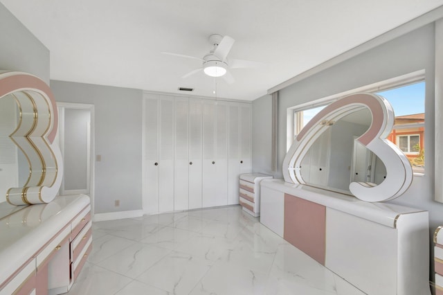 bathroom featuring visible vents, marble finish floor, a ceiling fan, and baseboards