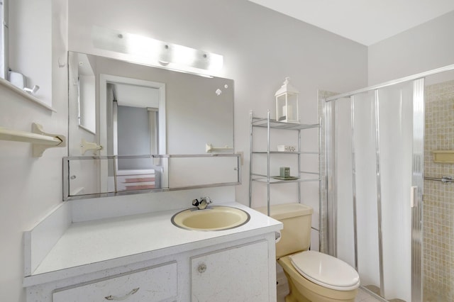 full bathroom with a stall shower, vanity, and toilet