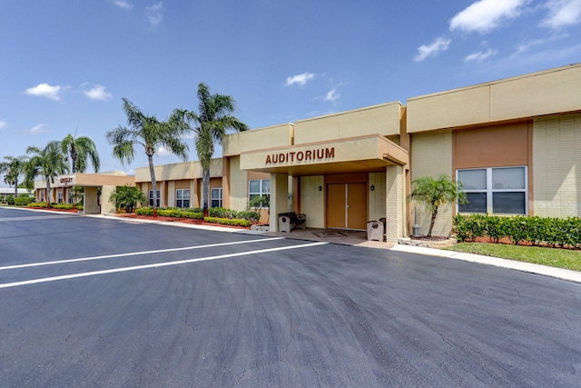 view of building exterior with uncovered parking