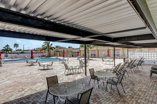 view of patio featuring fence and a community pool