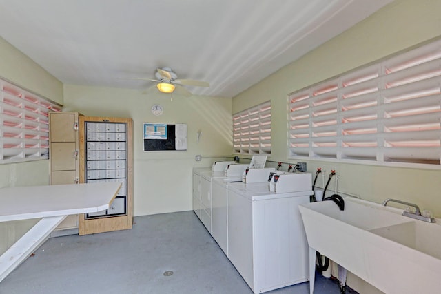 common laundry area featuring a sink, washer and clothes dryer, and ceiling fan