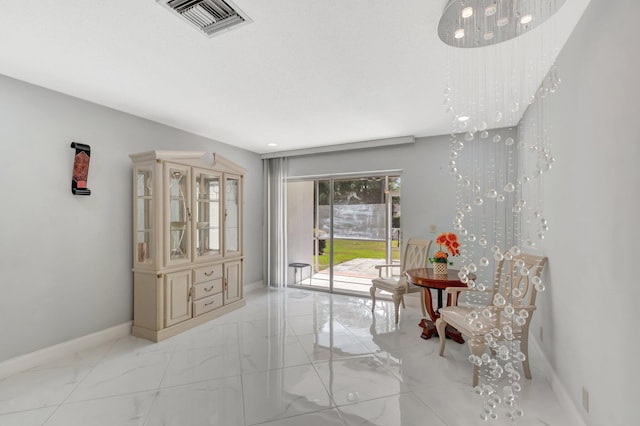 sitting room featuring marble finish floor, visible vents, and baseboards