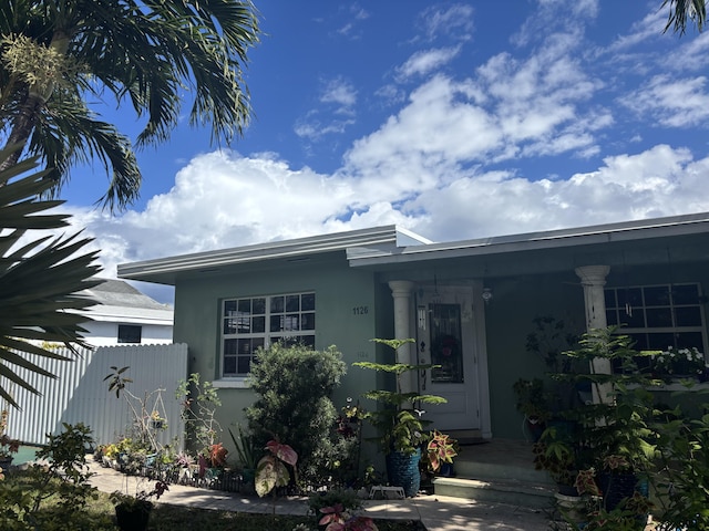 view of front of property featuring fence and stucco siding