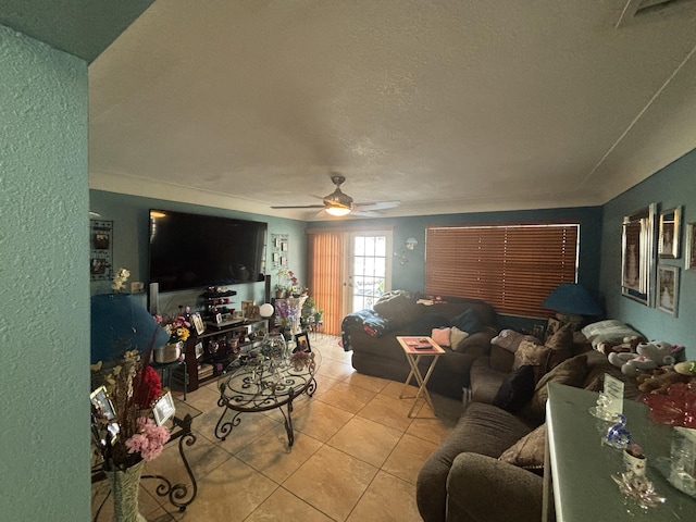 living room featuring a ceiling fan, a textured ceiling, and light tile patterned floors