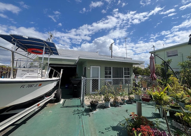 exterior space featuring a carport and fence