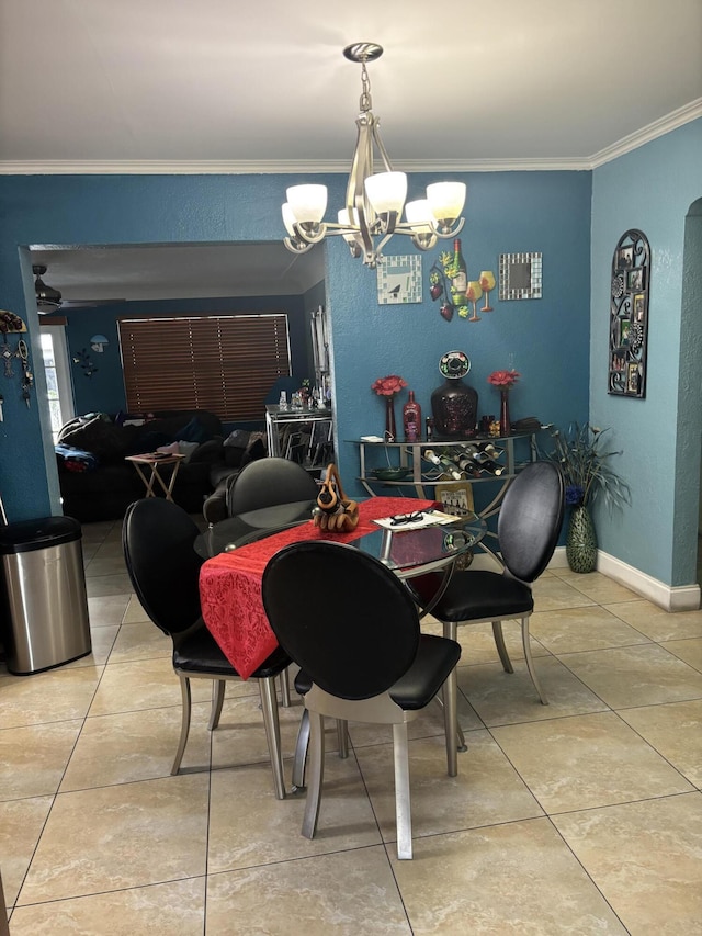 dining space featuring baseboards, ornamental molding, a notable chandelier, and tile patterned floors