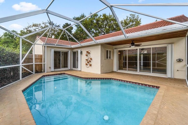 outdoor pool with a patio, ceiling fan, and fence