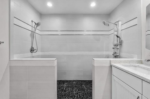 bathroom featuring vanity and a walk in shower