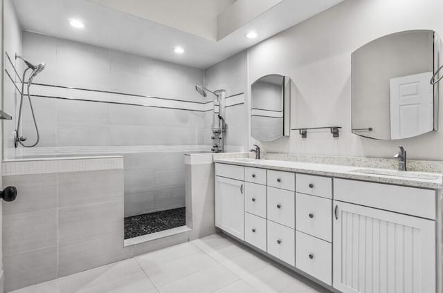 full bath featuring double vanity, recessed lighting, a walk in shower, and a sink