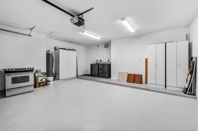 garage with a garage door opener, water heater, and washer and clothes dryer