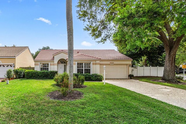 view of front of property with a front lawn, driveway, a tile roof, fence, and a garage