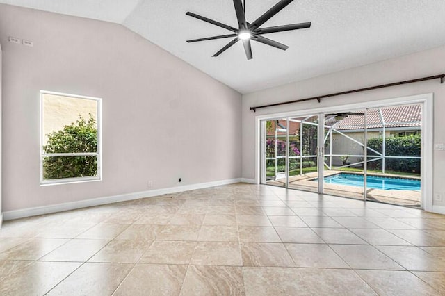 spare room featuring plenty of natural light, a ceiling fan, lofted ceiling, and a sunroom