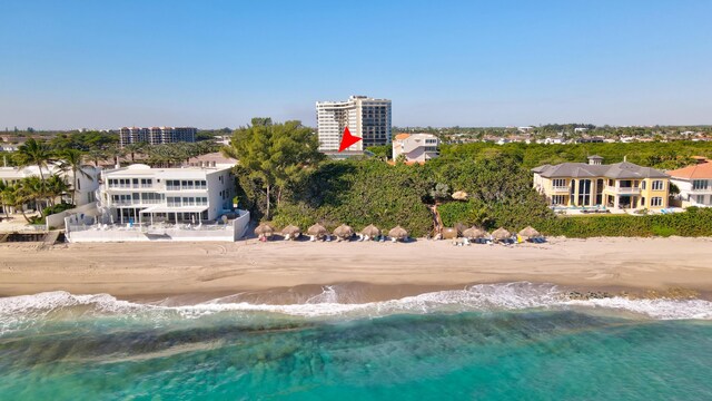 drone / aerial view with a water view and a view of the beach