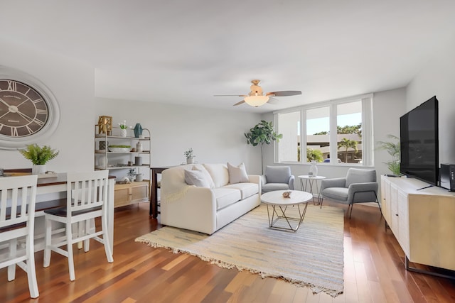 living area with a ceiling fan and wood finished floors