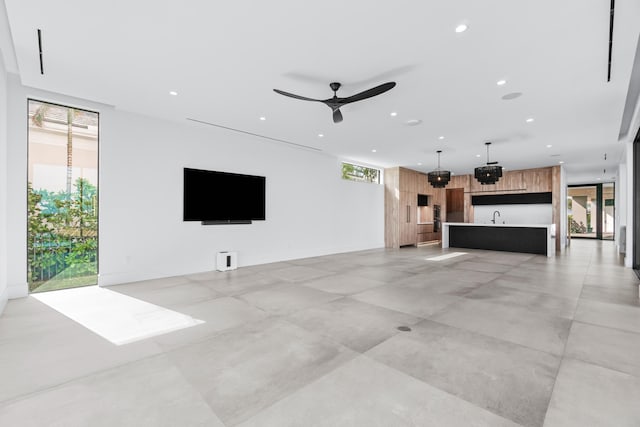 living room with a ceiling fan and recessed lighting