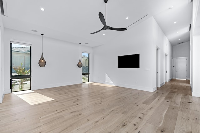 unfurnished living room featuring light wood-type flooring, a ceiling fan, and recessed lighting