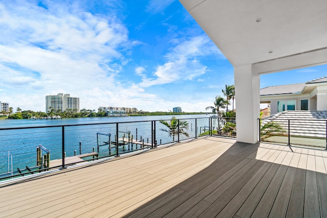 exterior space with a view of city, a water view, and a dock