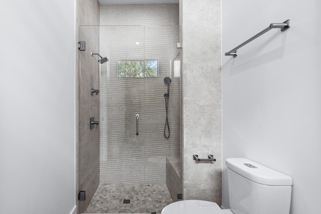 full bathroom with a shower stall and toilet