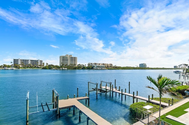 dock area with a water view, boat lift, and a city view