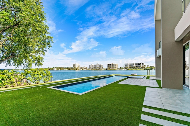 view of yard with a water view and a city view