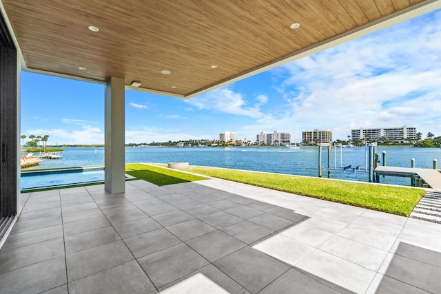 view of patio / terrace featuring a boat dock, a water view, boat lift, and a view of city