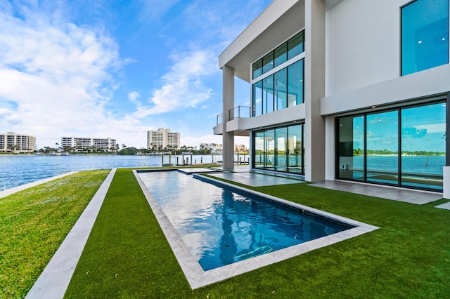 pool with a view of city, a water view, and a lawn